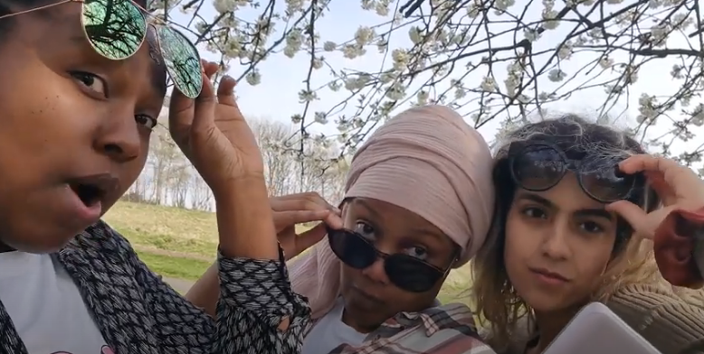 Three women pose with sunglasses for their new pop single.