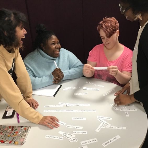 Group members laugh as they discuss lyrics