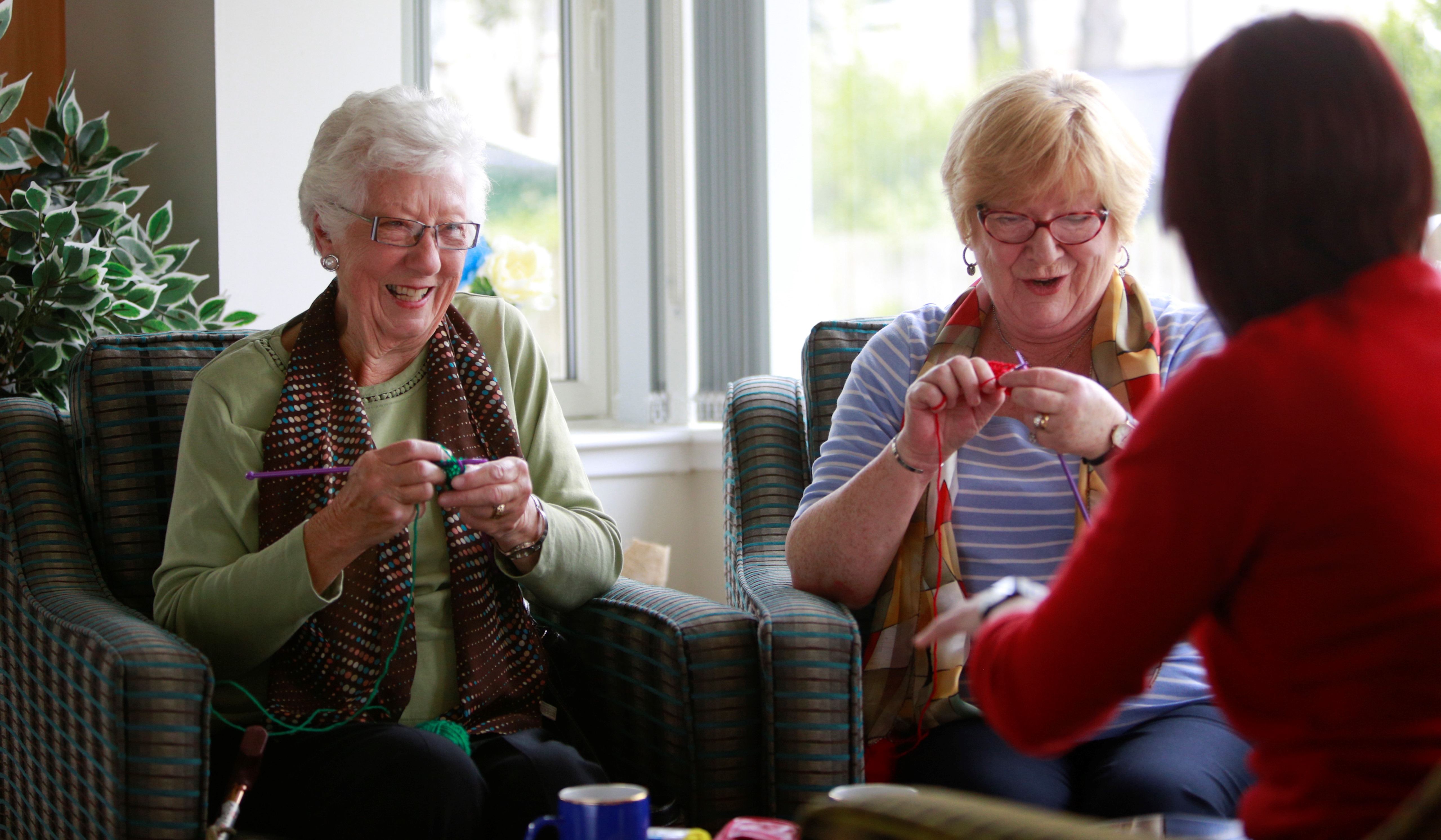 Two customers enjoying their knitting class