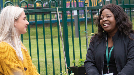 Image of two Wheatley Care staff talking on a bench